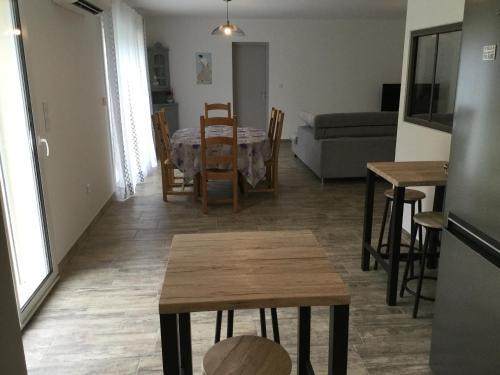 a kitchen and living room with a table and chairs at A pretty family house located in a tranquil area with a pretty view of the Luberon range. in Les Taillades