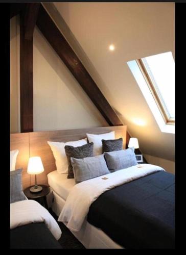 a bedroom with a large bed and a window at Sleephotels in Hamburg