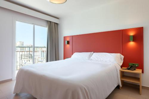 a bedroom with a large bed with a red headboard at The Red Hotel - Adults Only in San Antonio