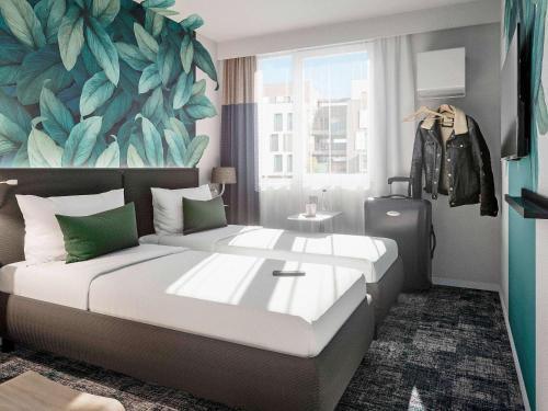 a bedroom with a large bed with a large leaf wall at ibis Styles Bezons Paris La Défense in Bezons