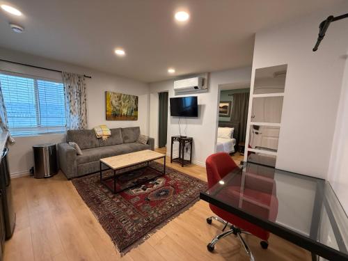 a living room with a couch and a table at Pasadena Old Town Cottage in Pasadena