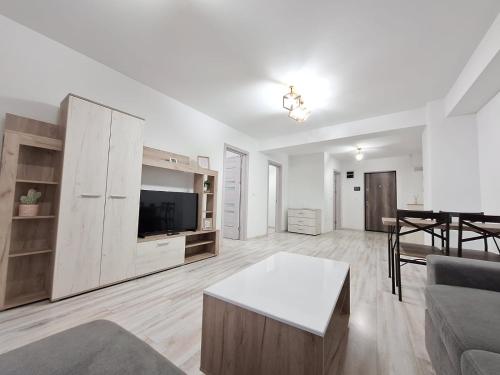 a living room with a couch and a table at Ultracentral 4Bedroom with 2 Bathrooms Cozy Apartment in Suceava in Suceava