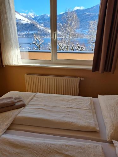 a bedroom with a bed and a window with a view at Appartement Alpensee in Zell am See