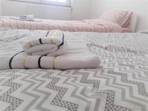a bed with two beds with towels on it at Ballet apartament in Skopje