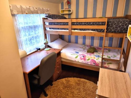 a bedroom with a desk and a bunk bed with a desk gmaxwell gmaxwell at Centrally located in Canterbury with two bedrooms and a sofa bed in Canterbury