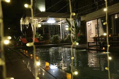 a swimming pool at night with lights on it at Flamigo Dai Lai Resort - Happy Villa in Ngọc Quang