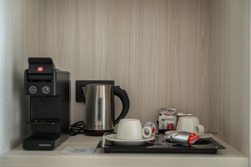 a coffeemaker and a coffee maker on a counter at Royal Marina Suites Boutique Hotel - Adults Only in Puerto Calero