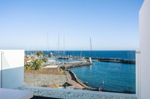 a view of a marina from a window at Royal Marina Suites Boutique Hotel - Adults Only in Puerto Calero