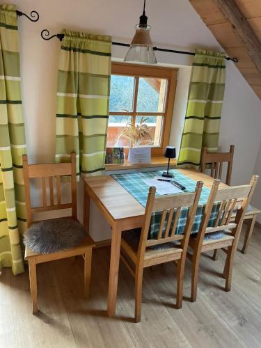 a dining room with a table and chairs and a window at Roggenstadl am Grandsberg in Schwarzach