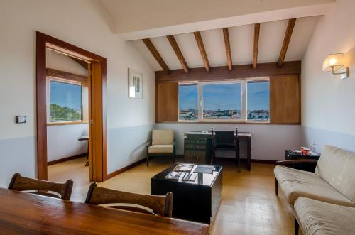 a living room with a couch and a table at Hotel Principe Real in Lisbon