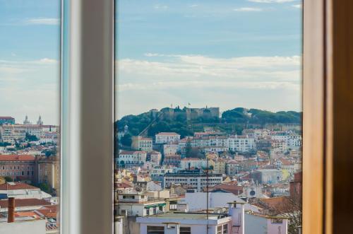 a view of a city from a window at Hotel Principe Real in Lisbon