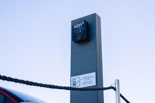 a car is parked next to a parking meter at Royal Marina Suites Boutique Hotel - Adults Only in Puerto Calero