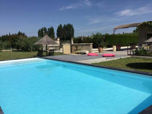 a large blue swimming pool in a yard at beautiful provencal mas with pool in barbentane, close to avignon, sleeps 8. in Barbentane