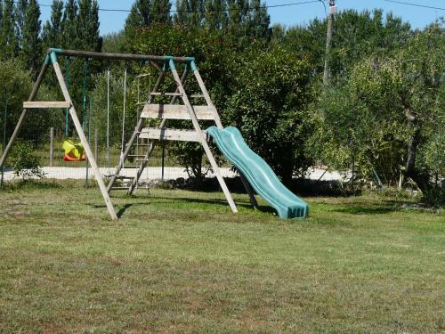 a playground with a slide in the grass at beautiful provencal mas with pool in barbentane, close to avignon, sleeps 8. in Barbentane
