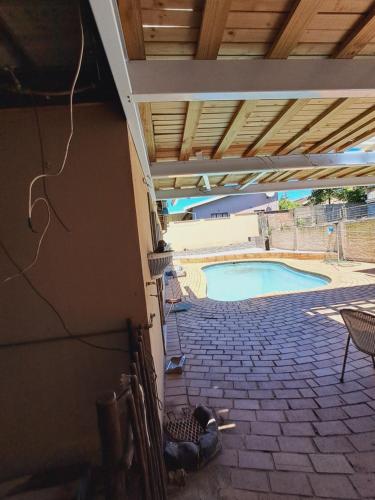 a view of a swimming pool from the outside of a house at Rubie's self-catering home in Durban