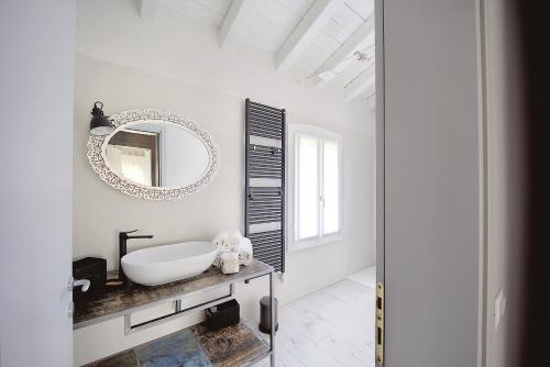 a white bathroom with a sink and a mirror at Maison sul Pozzo, Venicevillas in Venice
