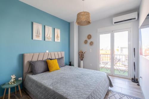 a bedroom with a bed with a blue wall at Glyfada center seaview B in Athens