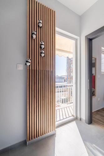 a room with a striped wall with a window at Glyfada center seaview B in Athens
