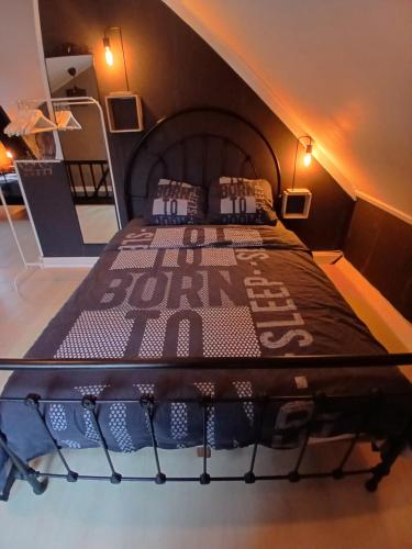 a large bed in a room with a bed frame at Vakantiehuis 2 Wheels 2 Relax in Wellen
