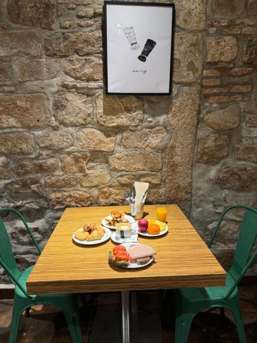 a wooden table with plates of food on it at Hostal Fernando in Barcelona