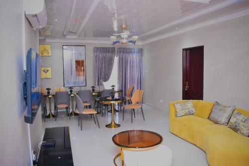 a living room with a couch and a table and chairs at Ken Koral Bed and Breakfast in Gaborone