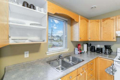 a kitchen with a sink and a window at Comfortable, Spacious 3 bedroom Home in Moncton