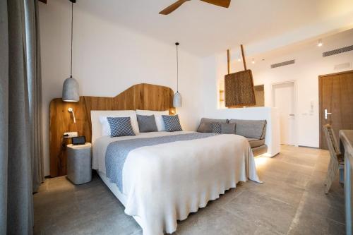 a bedroom with a large bed and a couch at Mileo in Kalo Livadi