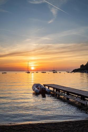 a person laying in the water next to a dock at Elbitat Homes in Bagnaia