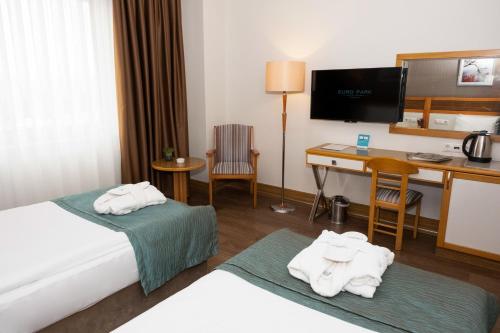 a hotel room with a bed and a desk at Euro Park Hotel Bursa in Bursa
