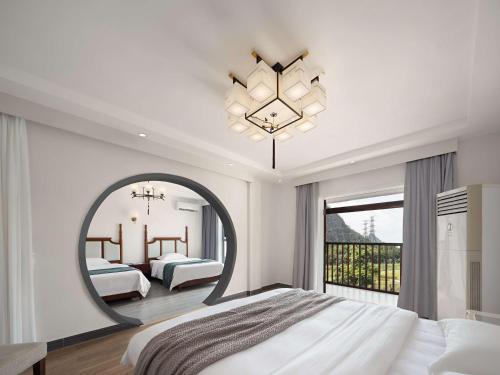 a bedroom with a large mirror and a bed at Serene Vale Inn Railway station free pick-up by 2 nights English and Spanish reception available in Guilin