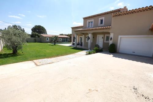 a driveway of a house with a garage at charming villa with heated pool, 14 people, located in aureille, near les baux de provence, in the alpilles in Aureille