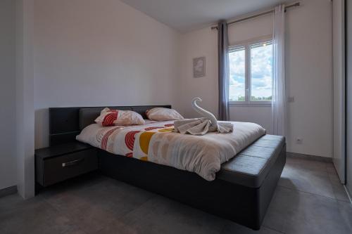 a bedroom with a large bed with a window at charming villa with heated pool, 14 people, located in aureille, near les baux de provence, in the alpilles in Aureille