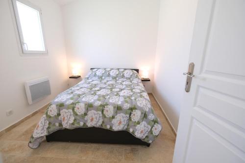 a bedroom with a bed with a blanket on it at charming villa with heated pool, 14 people, located in aureille, near les baux de provence, in the alpilles in Aureille