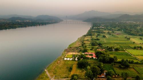 an aerial view of a river with a bridge at RiverView Tent Resort in Kevadia