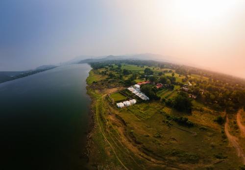 an island in the middle of a body of water at RiverView Tent Resort in Kevadia
