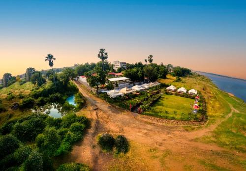 an aerial view of a resort on a hill next to the water at RiverView Tent Resort in Kevadia