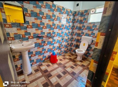 a bathroom with a sink and a toilet at ICONIC Hotel Digha in Digha