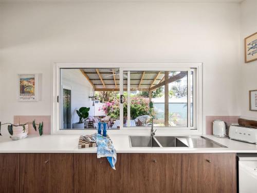 a kitchen with a sink and a window at Stylish Shack Falcon Bay in Wannanup