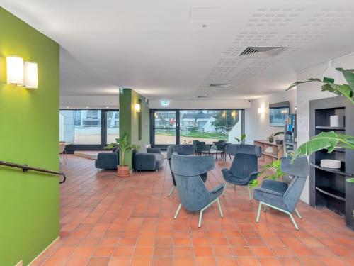 an office lobby with chairs and a waiting room at B&B HOTEL Alba in Alba