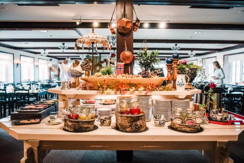 a buffet of food on a table in a restaurant at Vågslidtun Hotel in Vågsli