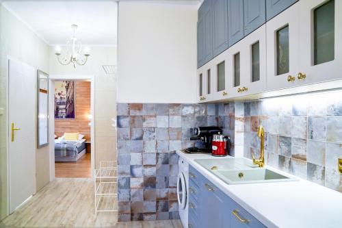 a kitchen with a sink and a counter at Prince Apartment by Baltic Home in Świnoujście