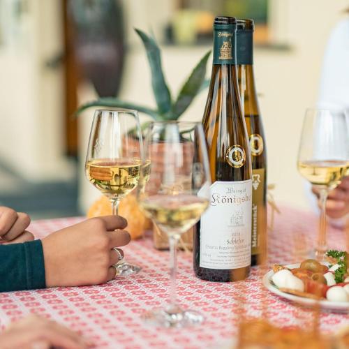 a bottle of white wine and two glasses on a table at Baudobriga Rheinhotel in Boppard