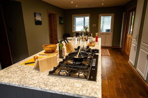 a kitchen with a stove and a counter top at Sachsblick in Lochgoilhead
