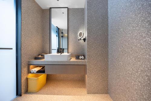 a bathroom with a sink and a mirror at Atour S Hotel Chongqing Yubei Central Park in Yubei