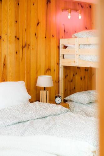 a bedroom with two bunk beds and a lamp at Villa Garmet Formigal in Formigal