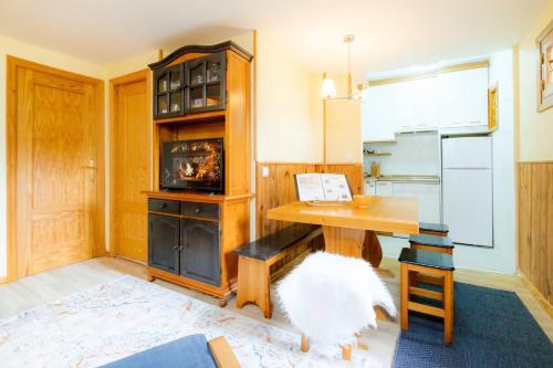 a kitchen with a wooden table and a desk at Villa Garmet Formigal in Formigal