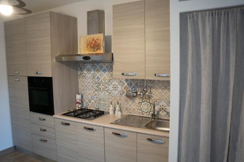 a kitchen with a stove and a sink in it at A Casa di Elsa in Sonnino