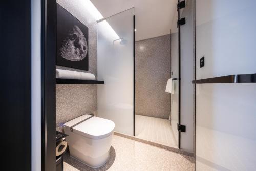 a bathroom with a toilet and a shower at Atour S Hotel Chongqing Yubei Central Park in Yubei