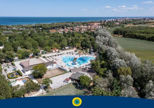 an aerial view of a resort with a swimming pool at Club del Sole Adriano Family Collection in Punta Marina