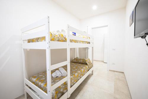 a white bunk bed in a white room at Villa Lumia in Tre Fontane